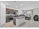 Bright and open kitchen featuring a center island, stainless steel appliances, and an adjacent dining area at 10664 Sariah Skye Ave, Las Vegas, NV 89166