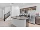 Modern kitchen features an island with granite countertops and stainless steel appliances at 10664 Sariah Skye Ave, Las Vegas, NV 89166