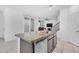 Granite kitchen island featuring stainless steel sink, dishwasher, and under-counter storage at 10664 Sariah Skye Ave, Las Vegas, NV 89166