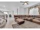 Spacious living room with large sectional sofa, tile floors, and an open floor plan at 10664 Sariah Skye Ave, Las Vegas, NV 89166