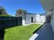 Wide view of the backyard featuring green artificial turf and pavers at 4281 White Sands Ave, Las Vegas, NV 89121