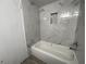 Bathroom featuring white tub and marble tile surround with inset shelf at 4281 White Sands Ave, Las Vegas, NV 89121