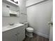 Simple bathroom featuring a white toilet, vanity, and mirror at 4281 White Sands Ave, Las Vegas, NV 89121