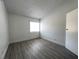 Bedroom featuring light gray vinyl flooring, white walls, and a window at 4281 White Sands Ave, Las Vegas, NV 89121