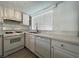 The updated kitchen features sleek quartz countertops, white cabinetry, and a modern dishwasher at 4281 White Sands Ave, Las Vegas, NV 89121