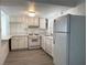 Updated kitchen with white cabinets, quartz countertops, and modern appliances at 4281 White Sands Ave, Las Vegas, NV 89121