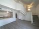 Bright open-concept living room with a modern kitchen view, sleek flooring, and stairs at 4281 White Sands Ave, Las Vegas, NV 89121