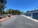 Neighborhood street view of townhomes with blue garages at 4281 White Sands Ave, Las Vegas, NV 89121