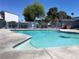 A view of the community pool surrounded by lush greenery at 4281 White Sands Ave, Las Vegas, NV 89121