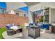 Inviting backyard patio area with comfortable seating, fire pit, and sun shade at 10407 Restless River St, Las Vegas, NV 89141