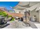 Outdoor oasis featuring a patio, seating, shade covering, and a unique water feature at 10407 Restless River St, Las Vegas, NV 89141