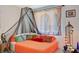 Eclectic bedroom features a bed, a canopy and colorful throw pillows at 10407 Restless River St, Las Vegas, NV 89141