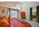 Bright bedroom featuring plush bedding, chandelier, and mountain views at 10407 Restless River St, Las Vegas, NV 89141