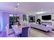 Open-concept dining and living area featuring sleek lighting, modern decor, and bright natural light at 10407 Restless River St, Las Vegas, NV 89141