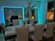 Bright dining area with reflective mirrors, sleek table setting, and modern chandelier at 10407 Restless River St, Las Vegas, NV 89141
