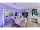 Dining area with mirrored wall, seating for six, and stylish chandelier at 10407 Restless River St, Las Vegas, NV 89141