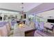 Bright dining area with open view to a modern kitchen featuring stylish seating and a stunning chandelier at 10407 Restless River St, Las Vegas, NV 89141