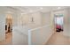 Bright upstairs hallway leading to bedrooms and laundry room at 10407 Restless River St, Las Vegas, NV 89141