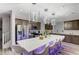 Modern kitchen featuring stainless steel appliances, a large island, and stylish pendant lighting at 10407 Restless River St, Las Vegas, NV 89141