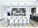 Modern kitchen featuring stainless steel appliances, a large island with bar seating, and sleek finishes at 10407 Restless River St, Las Vegas, NV 89141