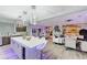 Open-concept living area featuring modern kitchen with an island, dining area and comfortable living space at 10407 Restless River St, Las Vegas, NV 89141