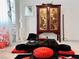 Close-up of a coffee table with a Asian inspired wooden cabinet in the background at 10407 Restless River St, Las Vegas, NV 89141