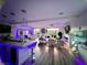 Open-concept living room with hardwood floors, modern lighting and fireplace, seamlessly connecting living spaces at 10407 Restless River St, Las Vegas, NV 89141