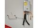 Tankless water heater mounted on the wall, offering energy-efficient and on-demand hot water at 10407 Restless River St, Las Vegas, NV 89141