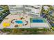 This view of a luxury condo building features a pool, tennis court, lush landscaping, and ample parking at 3111 Bel Air Dr # 28C, Las Vegas, NV 89109