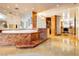 Extravagant bathroom with marble accents, a large soaking tub, glass block features and gold tile flooring at 3111 Bel Air Dr # 28C, Las Vegas, NV 89109
