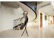 Grand foyer with a modern spiral staircase and sleek coat rack at 3111 Bel Air Dr # 28C, Las Vegas, NV 89109