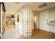 Bright hallway with a unique glass block wall and marble flooring at 3111 Bel Air Dr # 28C, Las Vegas, NV 89109