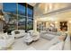 Modern living room featuring floor-to-ceiling windows, a sleek sectional sofa, and stunning city views at 3111 Bel Air Dr # 28C, Las Vegas, NV 89109