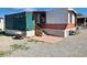 Exterior shot of a manufactured home with an open porch and access steps at 1130 N Leslie St, Pahrump, NV 89060