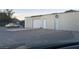 Exterior shot of a large garage with multiple doors and a car parked nearby at 1130 N Leslie St, Pahrump, NV 89060