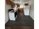 Functional kitchen featuring wood cabinets, white appliances and durable gray flooring at 1130 N Leslie St, Pahrump, NV 89060