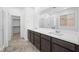 Contemporary bathroom with double vanity, modern walk-in shower, and stylish fixtures at 98 Via Franello, Henderson, NV 89011