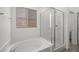 A bright bathroom with a window above a tub and adjacent shower at 98 Via Franello, Henderson, NV 89011