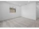 An empty room features a window view, neutral paint, and carpet flooring at 98 Via Franello, Henderson, NV 89011