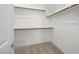 A well-organized walk-in closet with white walls and wood shelving at 98 Via Franello, Henderson, NV 89011
