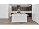 Kitchen featuring quartz countertops, stainless steel appliances, island, and dark cabinets at 98 Via Franello, Henderson, NV 89011