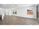 Living room featuring an open floorplan, two windows, sliding glass door, and wood tile flooring at 98 Via Franello, Henderson, NV 89011