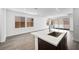 Living room featuring an open floorplan, island sink, sliding glass door, and wood tile flooring at 98 Via Franello, Henderson, NV 89011
