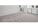 Spacious loft area featuring neutral carpet and black metal railing at 98 Via Franello, Henderson, NV 89011