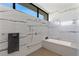 Spa-like bathroom with a soaking tub, walk-in shower, and marble tile at 9 Boulderback Dr, Henderson, NV 89012