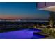 Infinity pool with city views at night at 9 Boulderback Dr, Henderson, NV 89012