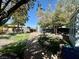 Expansive backyard featuring a covered patio and mature trees providing ample shade at 3895 Mountain Trl, Las Vegas, NV 89108