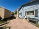 Backyard area featuring a paved patio and storage shed with side access to the house at 3895 Mountain Trl, Las Vegas, NV 89108