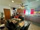 Bright dining area with wood cabinets, stainless steel appliances, and a glass dining table at 3895 Mountain Trl, Las Vegas, NV 89108