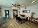 Cozy dining area featuring a modern glass-top table, seating for six, and stainless steel refrigerator at 3895 Mountain Trl, Las Vegas, NV 89108